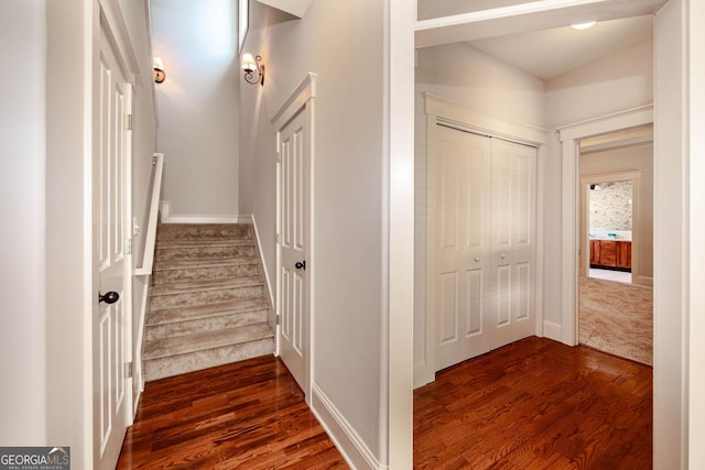 65 Orchard Dr, Covington, GA 30014 - hall with dark wood-style flooring, stairway, and baseboards