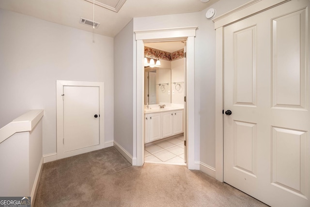 65 Orchard Dr, Covington, GA 30014 - corridor featuring light colored carpet, attic access, and baseboards