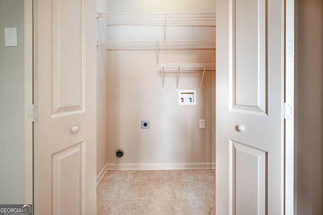 65 Orchard Dr, Covington, GA 30014 - laundry room with washer hookup, hookup for an electric dryer, baseboards, and tile patterned floors