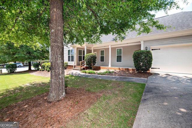 65 Orchard Dr, Covington, GA 30014 - view of front of home featuring a shingled roof, a porch, driveway, an attached garage, and a front lawn