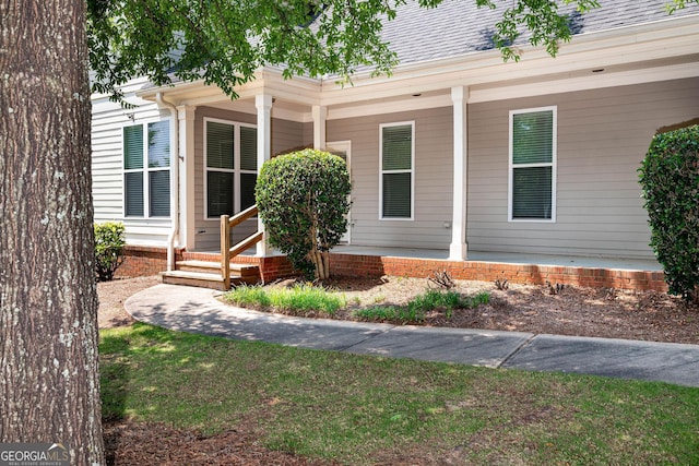 65 Orchard Dr, Covington, GA 30014 - property entrance with a porch and roof with shingles