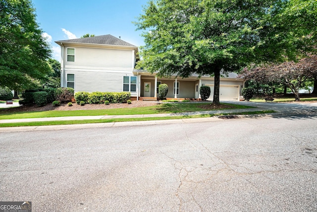 65 Orchard Dr, Covington, GA 30014 - view of front facade with an attached garage and driveway