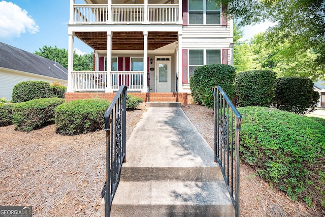 65 Orchard Dr, Covington, GA 30014 - property entrance featuring a porch, a gate, and a balcony