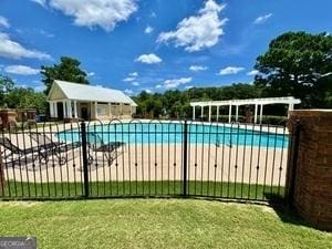 65 Orchard Dr, Covington, GA 30014 - community pool featuring a patio area
