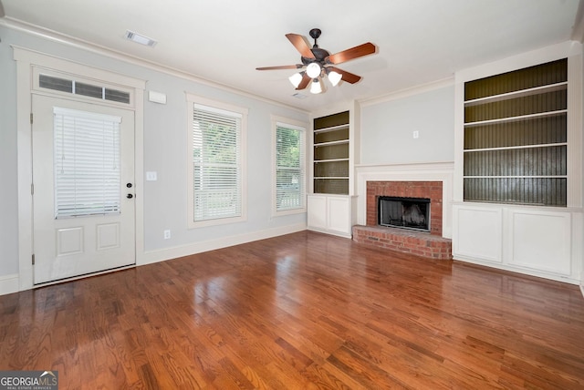65 Orchard Dr, Covington, GA 30014 - unfurnished living room with built in features, ceiling fan, baseboards, wood finished floors, and ornamental molding