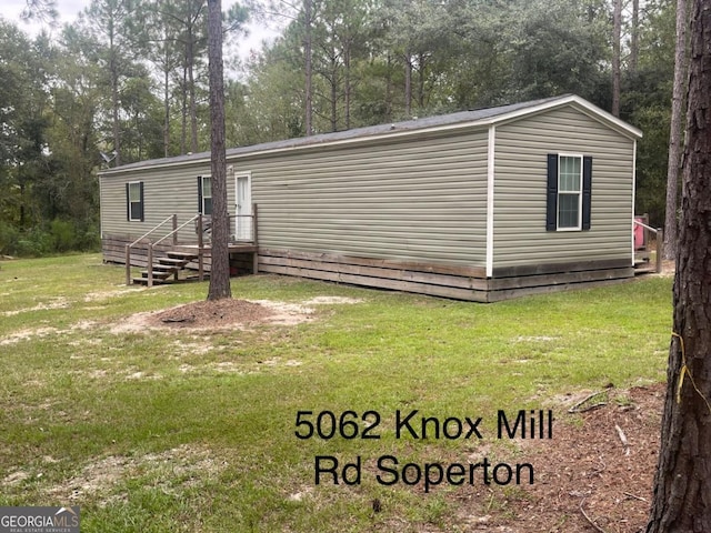 000375 Brooks Kirkland Rd, Vidalia, GA 30474 - rear view of property featuring a yard and view of scattered trees