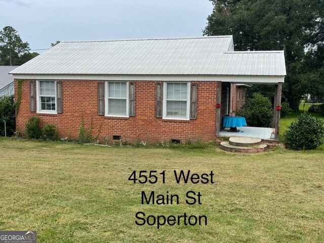 000375 Brooks Kirkland Rd, Vidalia, GA 30474 - view of front facade with a front lawn, crawl space, metal roof, and brick siding