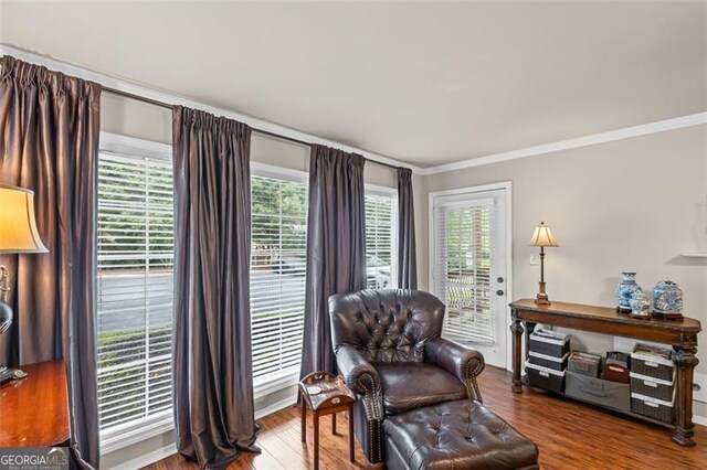 202 Berkeley Woods Dr, Duluth, GA 30096 - living area featuring ornamental molding, wood finished floors, and baseboards