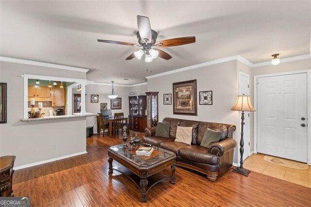 202 Berkeley Woods Dr, Duluth, GA 30096 - living area with a ceiling fan, baseboards, wood finished floors, and ornamental molding