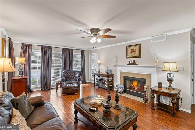 202 Berkeley Woods Dr, Duluth, GA 30096 - living area with ceiling fan, ornamental molding, a fireplace, wood finished floors, and baseboards
