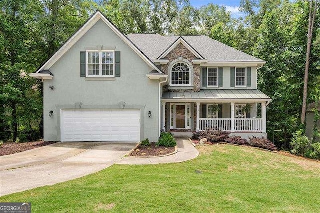 2342 Tall Timbers Ln, Marietta, GA 30066 - view of front of home with covered porch, an attached garage, a standing seam roof, and stucco siding