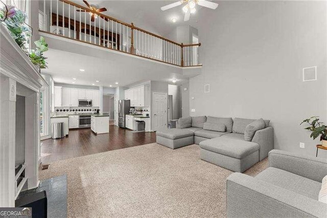 2342 Tall Timbers Ln, Marietta, GA 30066 - living area with a ceiling fan, a towering ceiling, and dark wood-type flooring
