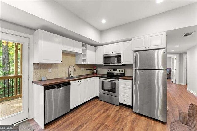 2342 Tall Timbers Ln, Marietta, GA 30066 - kitchen with appliances with stainless steel finishes, dark countertops, a sink, dark wood-style floors, and recessed lighting
