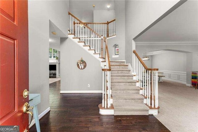 2342 Tall Timbers Ln, Marietta, GA 30066 - foyer with a high ceiling, stairs, arched walkways, baseboards, and hardwood / wood-style floors