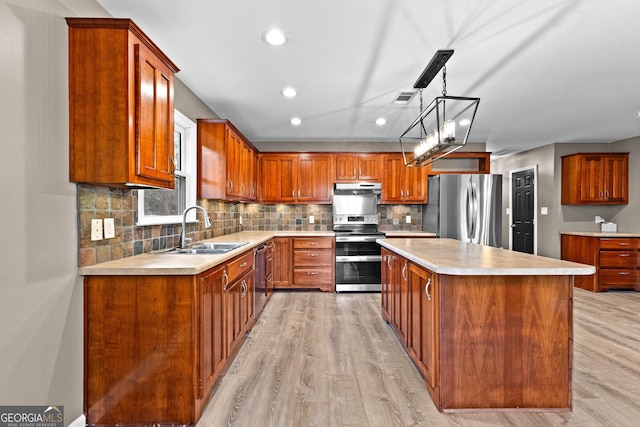 810 Callaway Church Rd, Lagrange, GA 30241 - kitchen with appliances with stainless steel finishes, under cabinet range hood, light wood finished floors, a center island, and recessed lighting