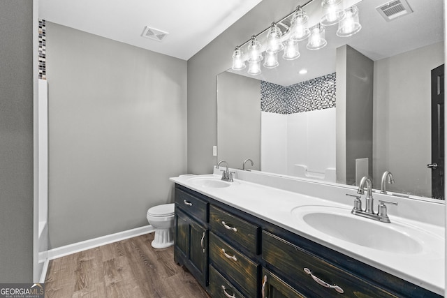 810 Callaway Church Rd, Lagrange, GA 30241 - bathroom with wood finished floors, double vanity, and shower / tub combination