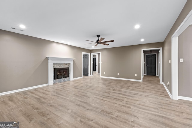 810 Callaway Church Rd, Lagrange, GA 30241 - unfurnished living room with a ceiling fan, light wood-type flooring, recessed lighting, and a stone fireplace
