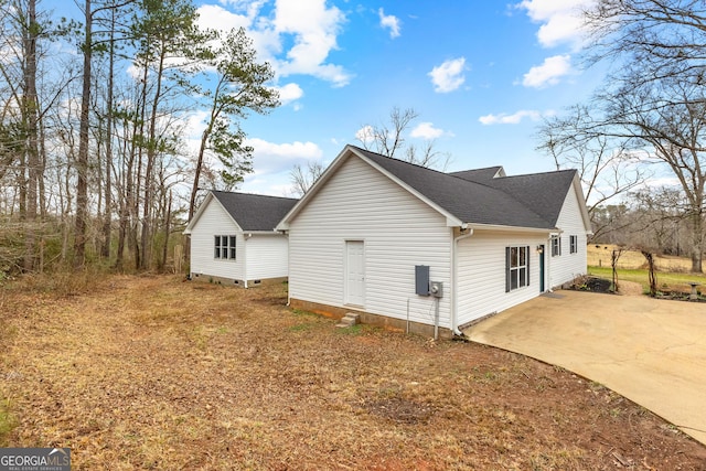 810 Callaway Church Rd, Lagrange, GA 30241 - view of side of home with driveway, a shingled roof, and a patio