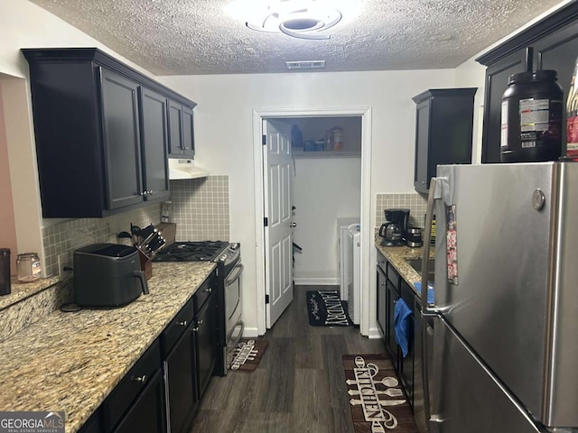 122 Sterling Ct Unit 122, Alpharetta, GA 30004 - kitchen featuring appliances with stainless steel finishes, dark wood-style floors, a textured ceiling, under cabinet range hood, and light stone counters