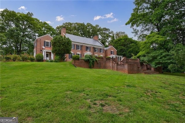 280 Blackland Rd NW, Atlanta, GA 30342 - back of house featuring a chimney and a yard