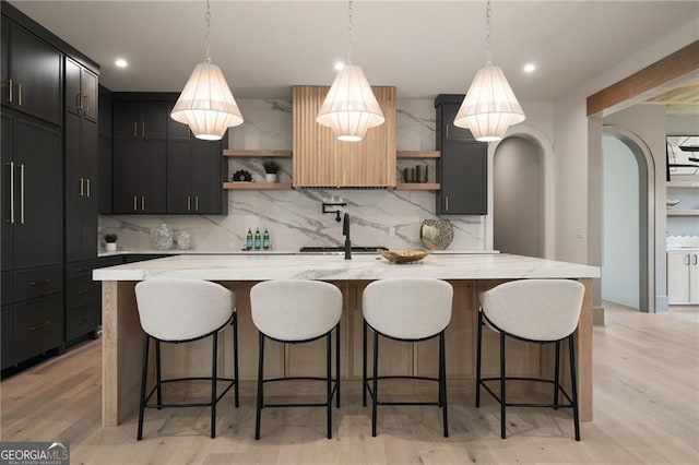 130 Nova Ln, Roswell, GA 30075 - kitchen with open shelves, tasteful backsplash, arched walkways, a breakfast bar, and recessed lighting