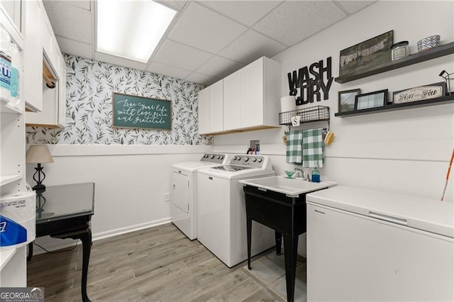 437 Jewell Slaton Rd, Dawsonville, GA 30534 - laundry room with cabinet space, wallpapered walls, washing machine and dryer, and light wood-type flooring