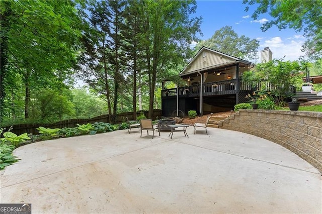 437 Jewell Slaton Rd, Dawsonville, GA 30534 - fenced backyard with an outdoor fire pit, a wooden deck, ceiling fan, and a patio