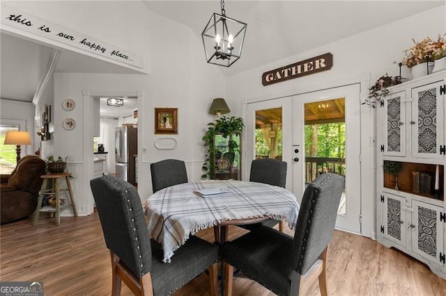 437 Jewell Slaton Rd, Dawsonville, GA 30534 - dining room with french doors, wood finished floors, a chandelier, and lofted ceiling