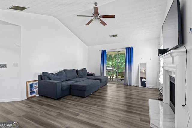 11581 Kades Trl, Hampton, GA 30228 - living room with lofted ceiling, a ceiling fan, a fireplace, wood finished floors, and baseboards