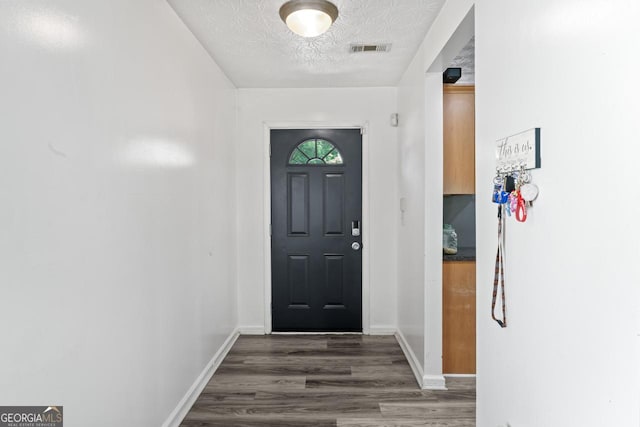 11581 Kades Trl, Hampton, GA 30228 - entrance foyer with wood finished floors, baseboards, and a textured ceiling
