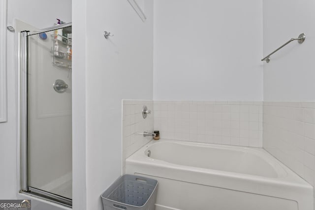 11581 Kades Trl, Hampton, GA 30228 - bathroom featuring a bath and a shower stall