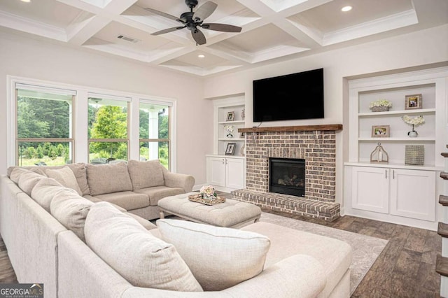 7345 Vale Ct, Cumming, GA 30028 - living room featuring wood finished floors, ceiling fan, beam ceiling, coffered ceiling, and a brick fireplace