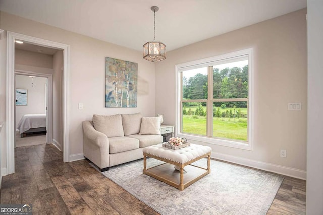 7345 Vale Ct, Cumming, GA 30028 - living area with baseboards, a chandelier, and dark wood-style flooring