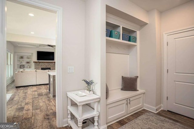 7345 Vale Ct, Cumming, GA 30028 - mudroom featuring dark wood-style flooring, a brick fireplace, a ceiling fan, baseboards, and built in features