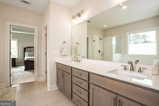 7345 Vale Ct, Cumming, GA 30028 - ensuite bathroom featuring a stall shower, double vanity, and baseboards
