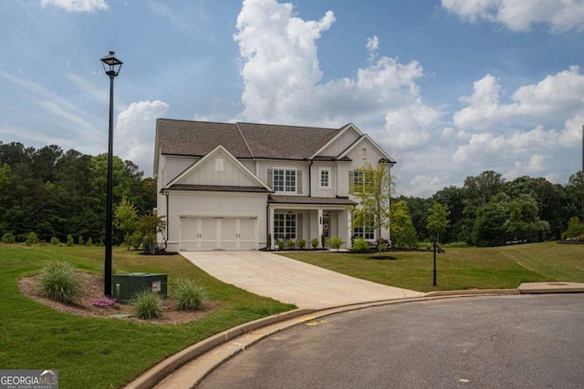 7345 Vale Ct, Cumming, GA 30028 - view of front of property with concrete driveway, a front lawn, a garage, board and batten siding, and roof with shingles