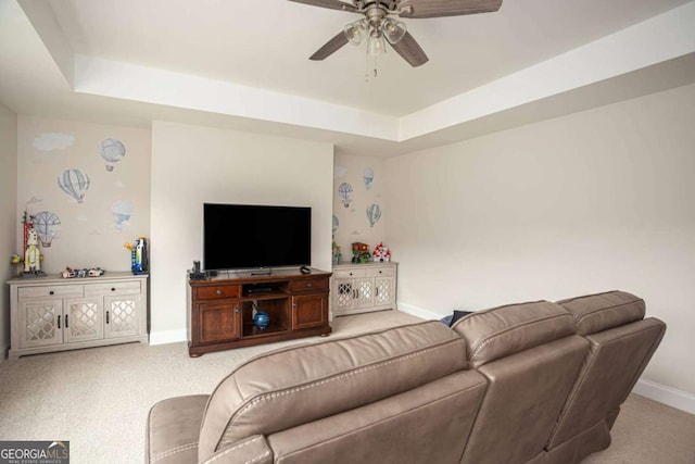 7345 Vale Ct, Cumming, GA 30028 - carpeted living room featuring a tray ceiling, baseboards, and a ceiling fan