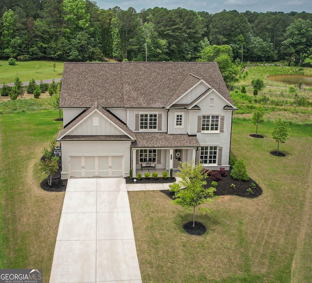 7345 Vale Ct, Cumming, GA 30028 - traditional-style house with roof with shingles, driveway, covered porch, and a front yard