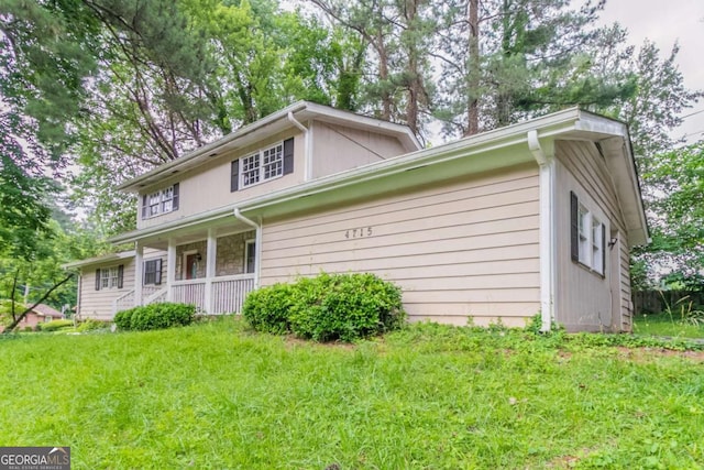 4715 Wildginger Run, Lithonia, GA 30038 - view of home's exterior with a porch and a lawn