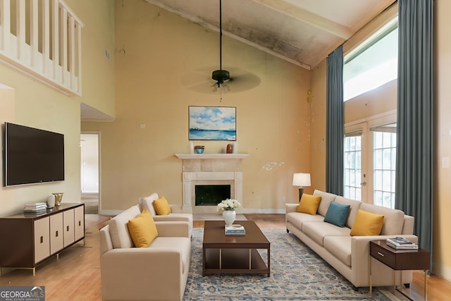 4715 Wildginger Run, Lithonia, GA 30038 - living area with wood finished floors, high vaulted ceiling, ceiling fan, baseboards, and a fireplace