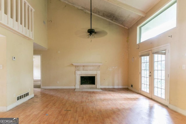 4715 Wildginger Run, Lithonia, GA 30038 - unfurnished living room with high vaulted ceiling, wood finished floors, ceiling fan, a premium fireplace, and baseboards