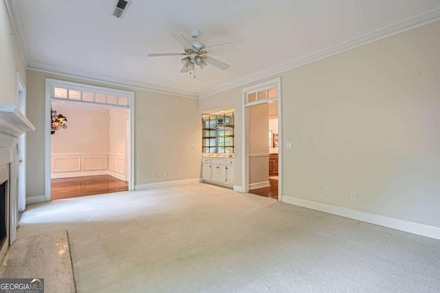 7155 Roswell Rd Unit 58, Atlanta, GA 30328 - unfurnished living room featuring crown molding, a ceiling fan, carpet, a fireplace, and baseboards