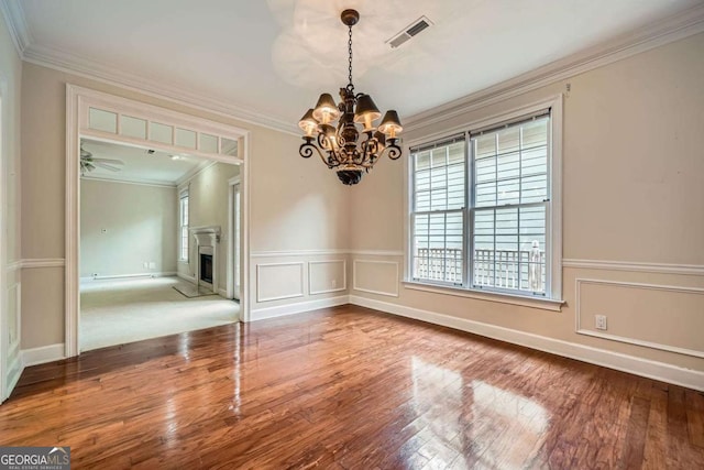7155 Roswell Rd Unit 58, Atlanta, GA 30328 - unfurnished dining area featuring a chandelier, wood finished floors, ornamental molding, a fireplace, and wainscoting