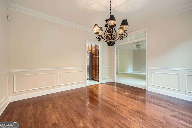 7155 Roswell Rd Unit 58, Atlanta, GA 30328 - unfurnished dining area featuring a chandelier, a decorative wall, wood finished floors, crown molding, and wainscoting