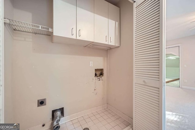 7155 Roswell Rd Unit 58, Atlanta, GA 30328 - laundry room featuring cabinet space, electric dryer hookup, baseboards, and light tile patterned flooring