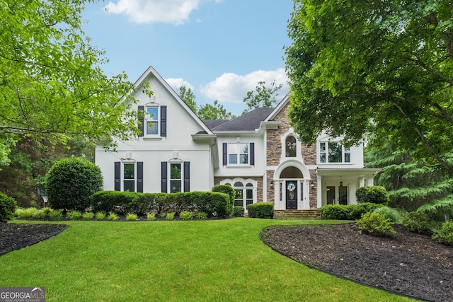 712 Brookshade Pkwy, Alpharetta, GA 30004 - view of front of house featuring stone siding, stucco siding, and a front lawn