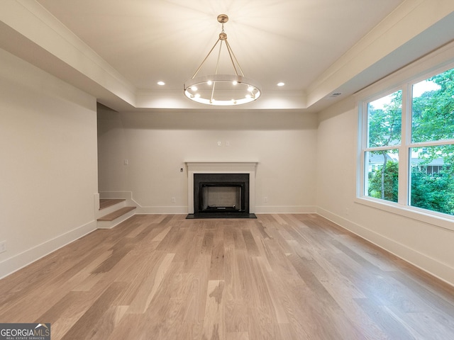 4955 Chamblee Dunwoody Rd, Dunwoody, GA 30338 - unfurnished living room featuring a tray ceiling, light wood-type flooring, a fireplace with flush hearth, healthy amount of natural light, and ornamental molding