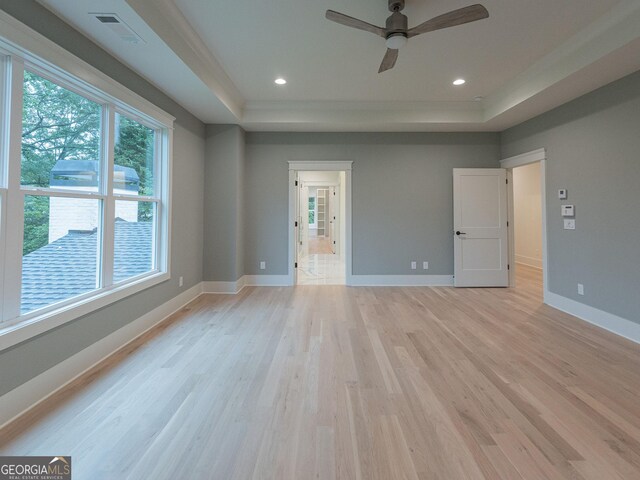 4955 Chamblee Dunwoody Rd, Dunwoody, GA 30338 - unfurnished bedroom featuring a tray ceiling, light wood-style flooring, recessed lighting, and ensuite bath