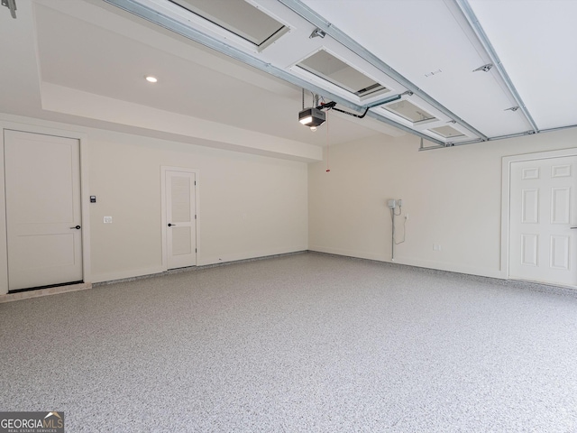 4955 Chamblee Dunwoody Rd, Dunwoody, GA 30338 - garage featuring a garage door opener and baseboards