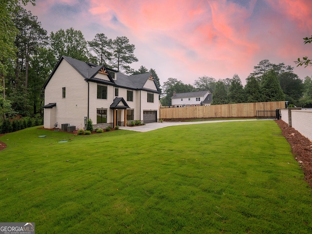 4955 Chamblee Dunwoody Rd, Dunwoody, GA 30338 - back of property at dusk with a garage and driveway